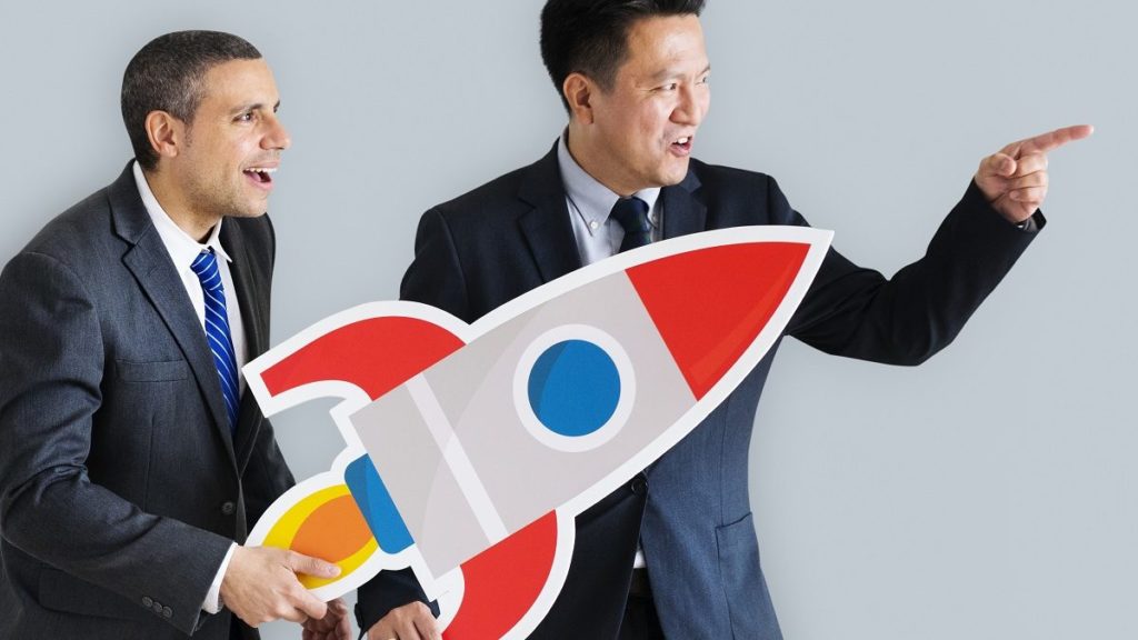 Businessmen Holding Launching Rocket Icon - Eu Contador Contabilidade Online